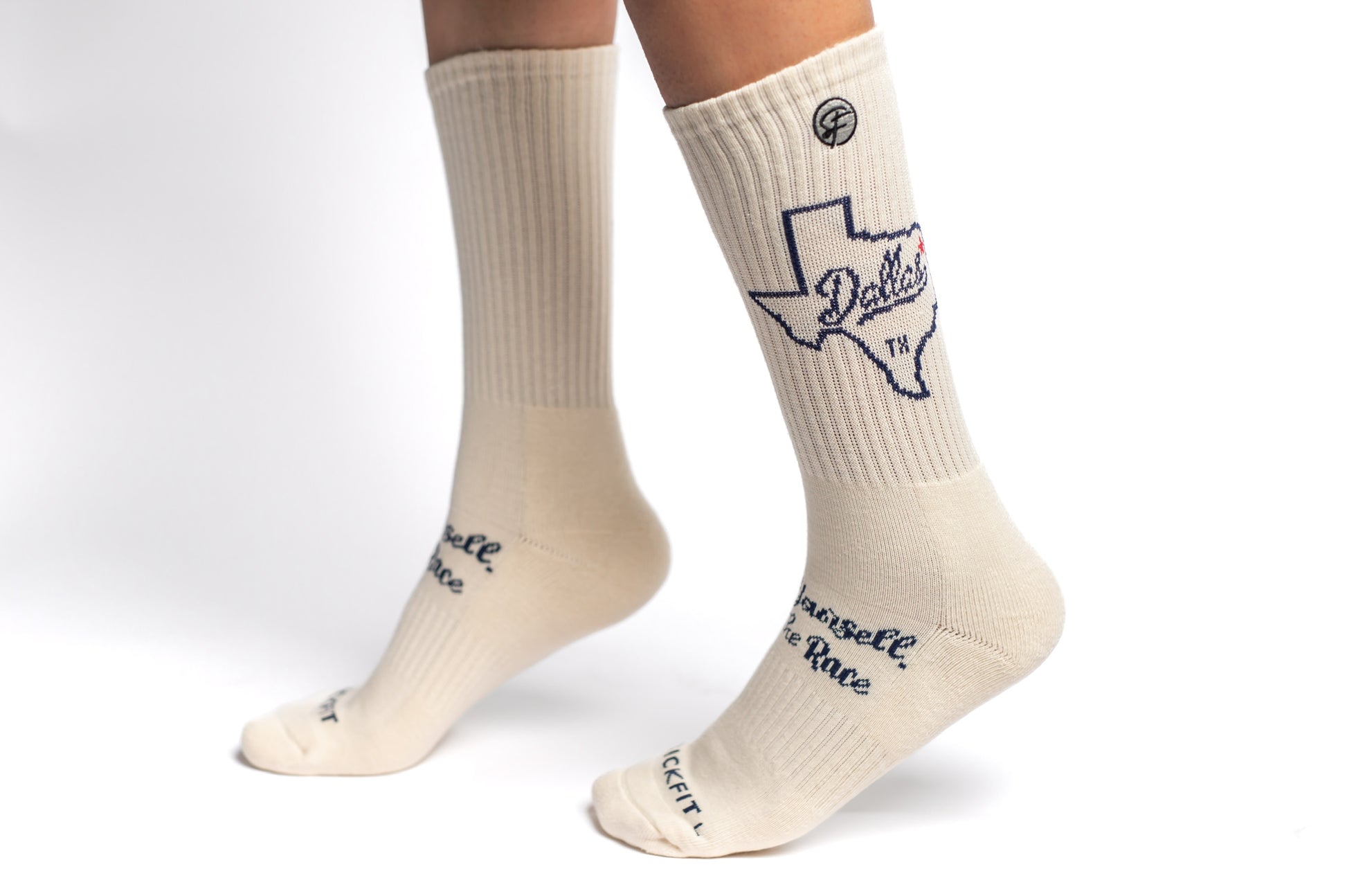 A pair of creme SickFit crew compression socks with state of Texas design and text.
