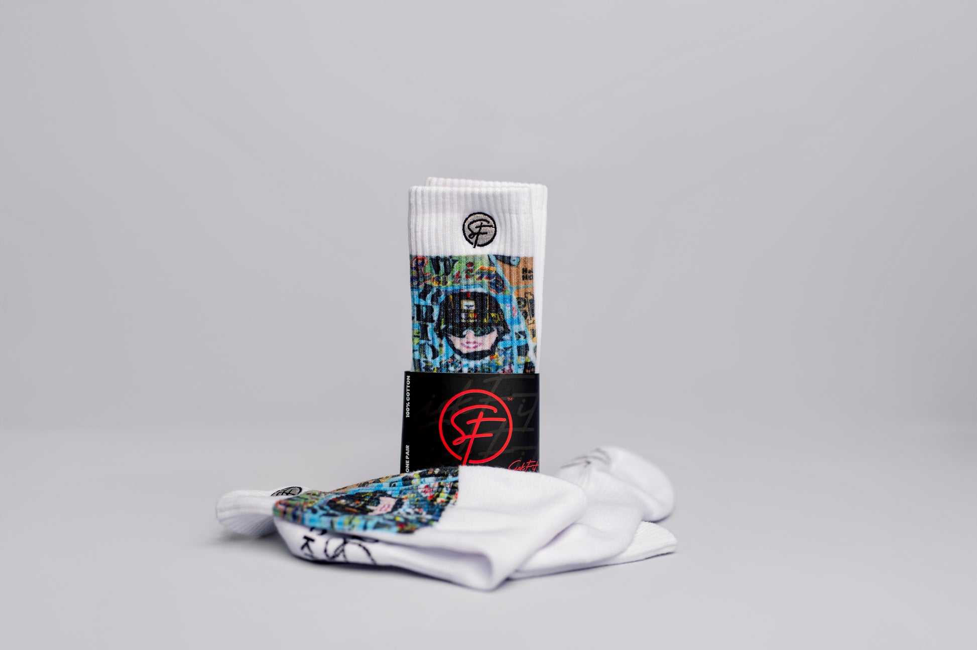 A pair of crew compression  socks with the cover art of a memoir titled 'Latina Warrior' displayed in the background.