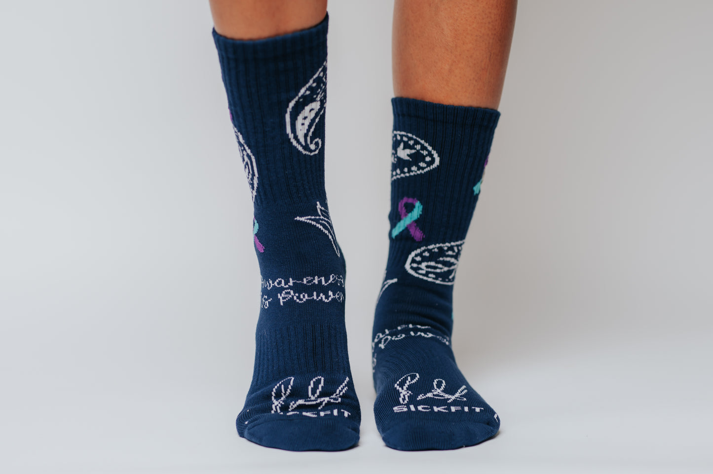 Navy blue crew compression socks with white designs for Bella's Story and text on a plain background