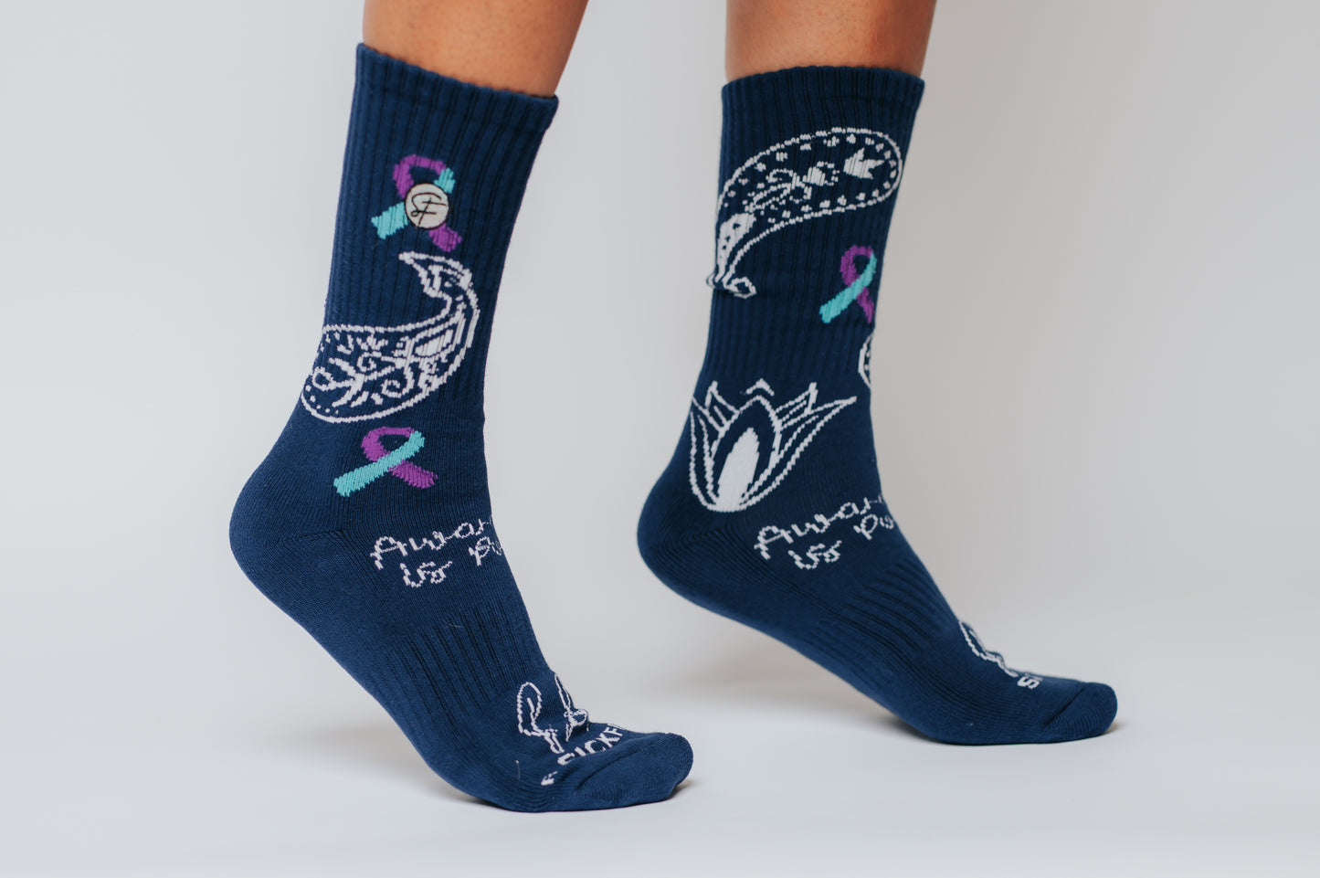 Navy blue crew compression socks with white designs for Bella's Story and text on a plain background