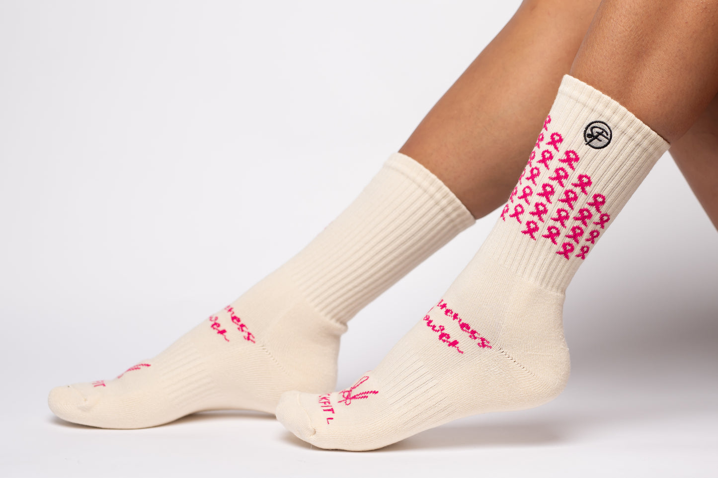 Creme crew compression socks with pink ribbons and text on a white background