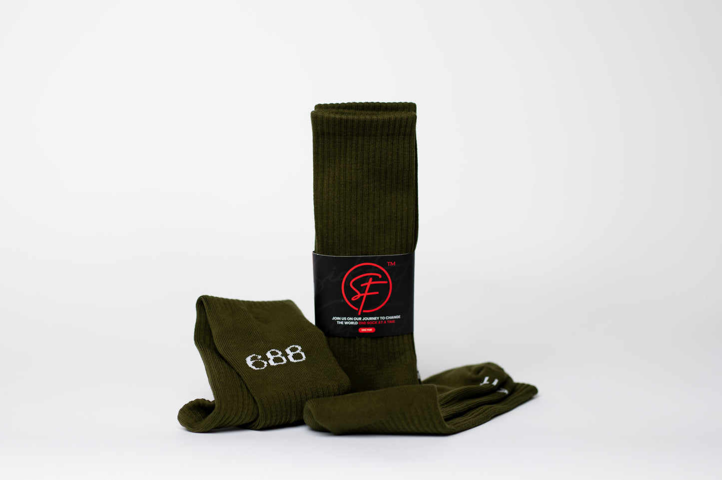 Green crew compression socks with a brand logo on a white background