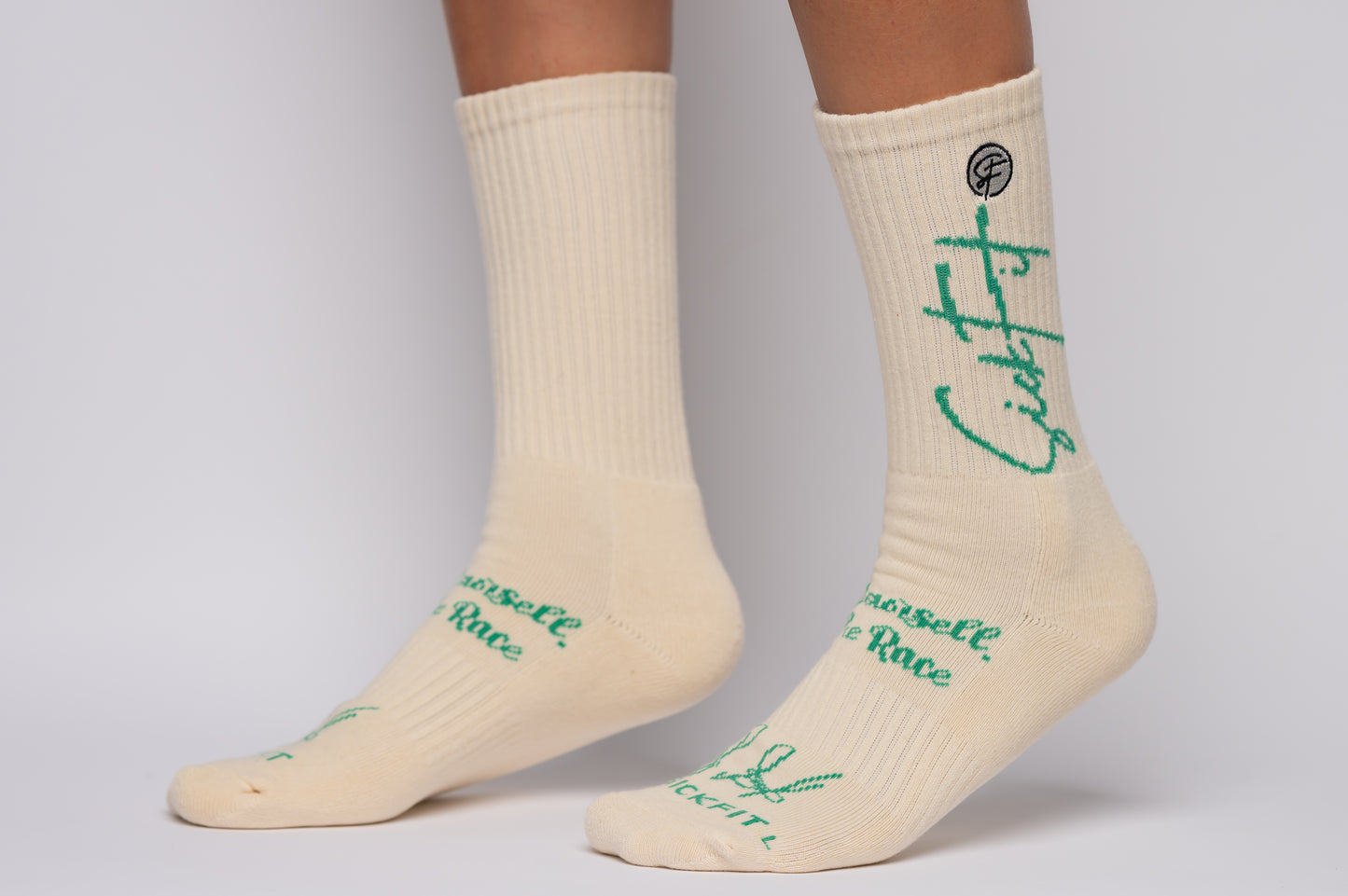SickFit socks with green text worn by a person on a gray background