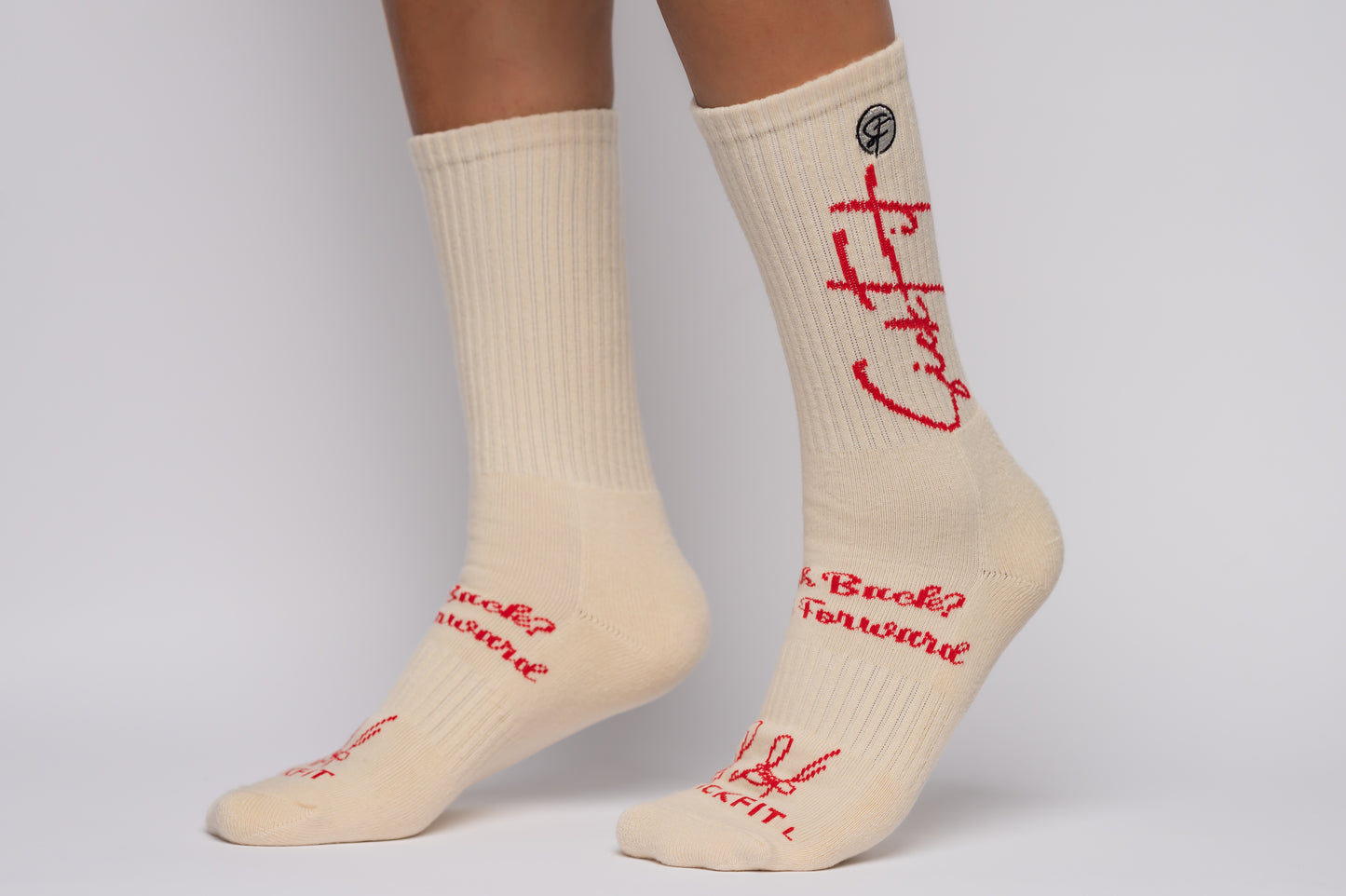 SickFit socks with red text worn by a person on a gray background