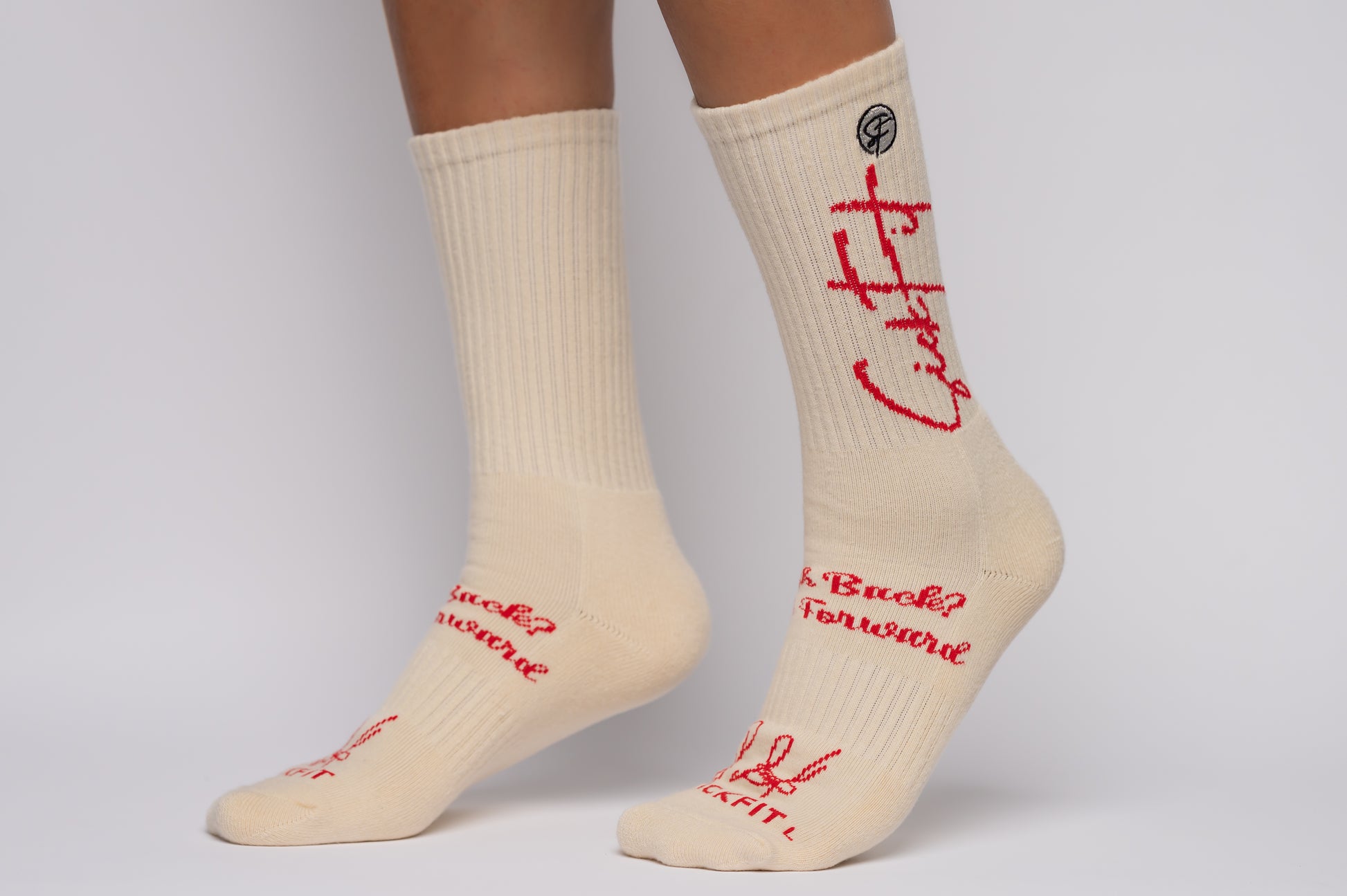SickFit socks with red text worn by a person on a gray background