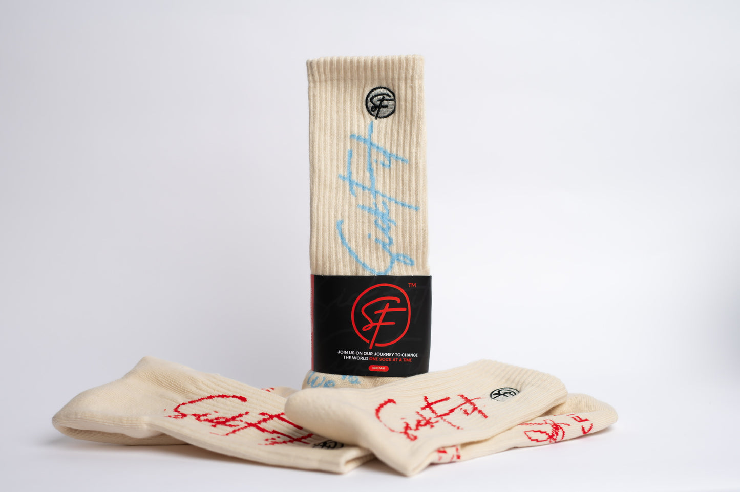 A pair of SickFit crew compression beige compression socks with red text on them, displayed next to a packaging tube with a logo and additional red text, alluding to a subscription service.