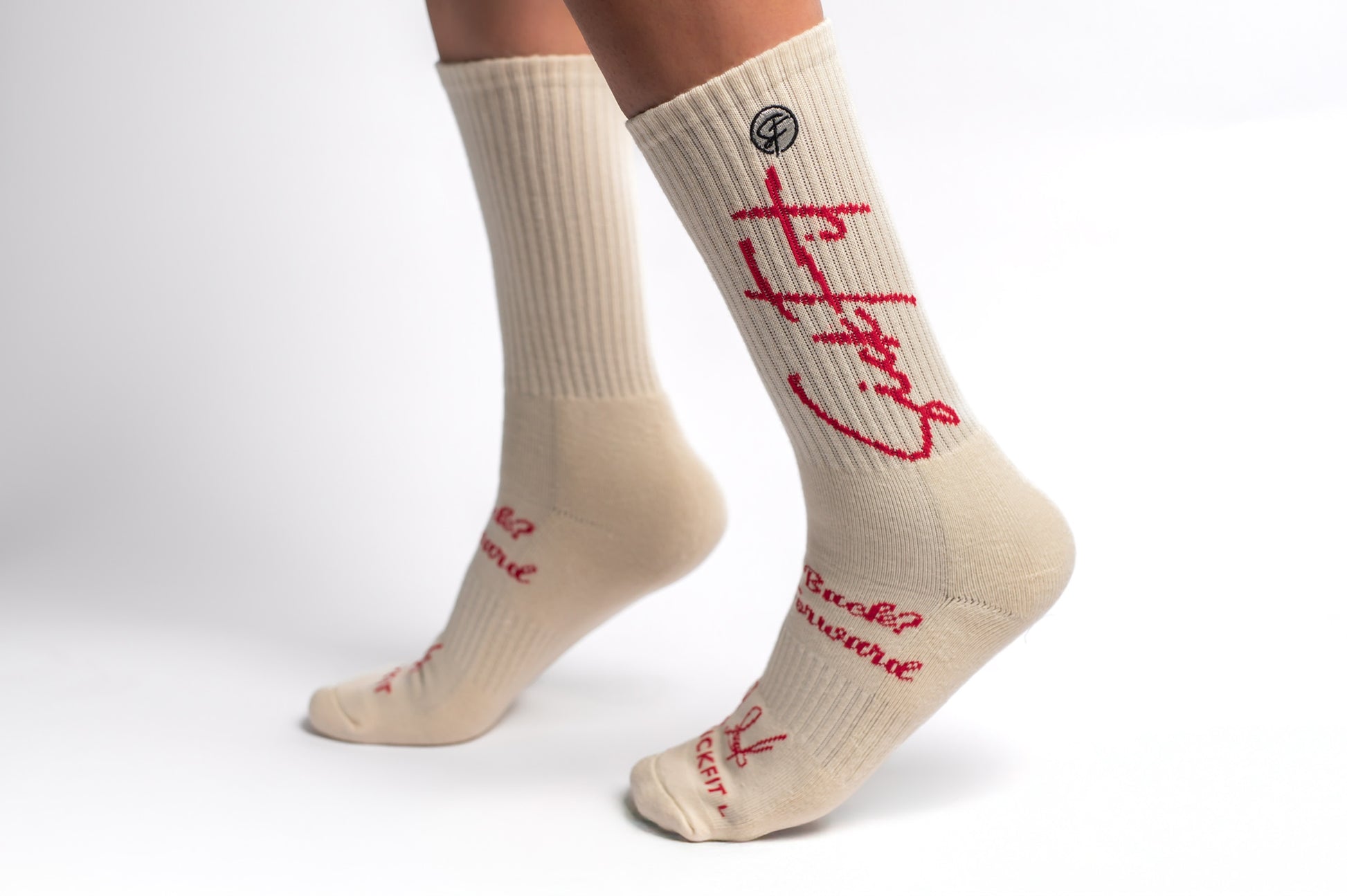 A pair of creme Sickfit Crew Compression socks with red text