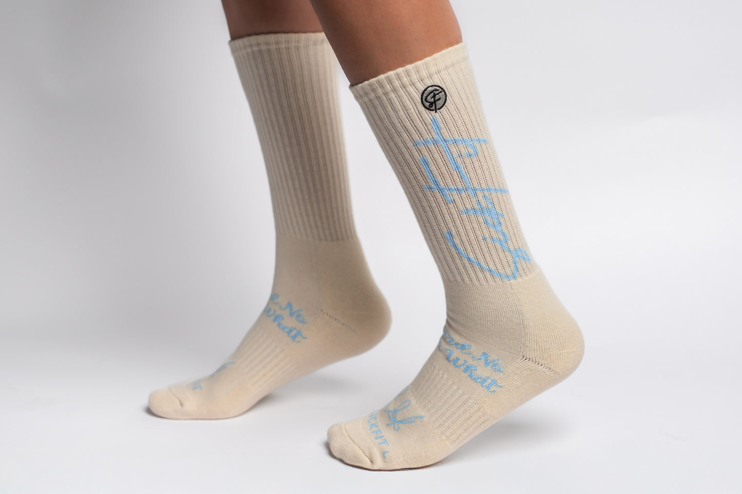 A pair of creme Sickfit Crew Compression socks with baby blue text
