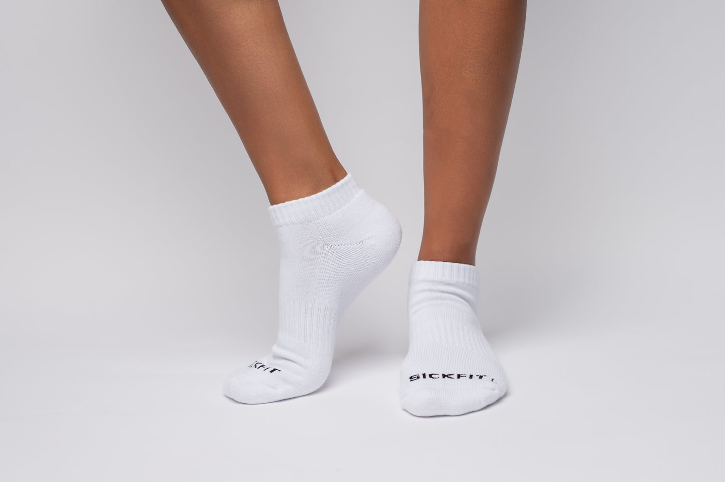 White ankle compression socks with text on a neutral background