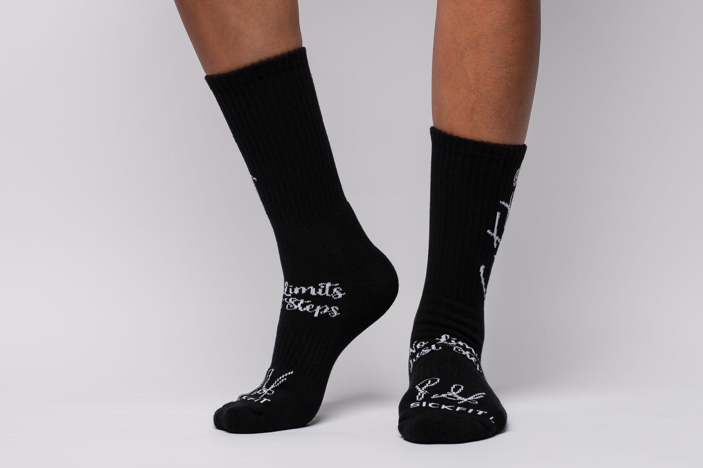 Black crew compression socks with white text on a neutral background
