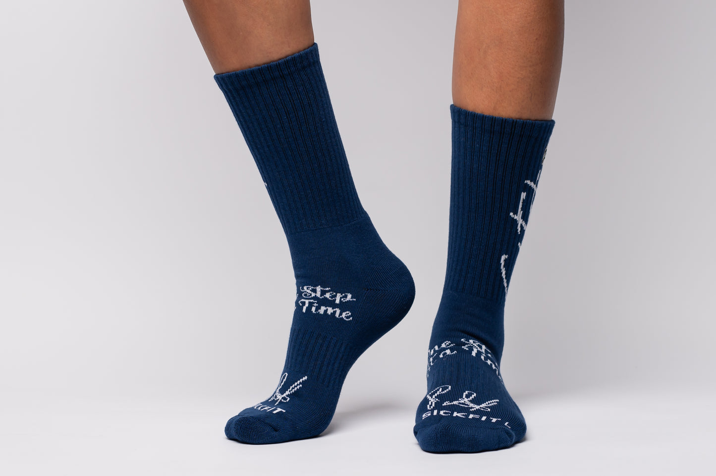 Navy blue crew compression socks with white text and designs on a plain background