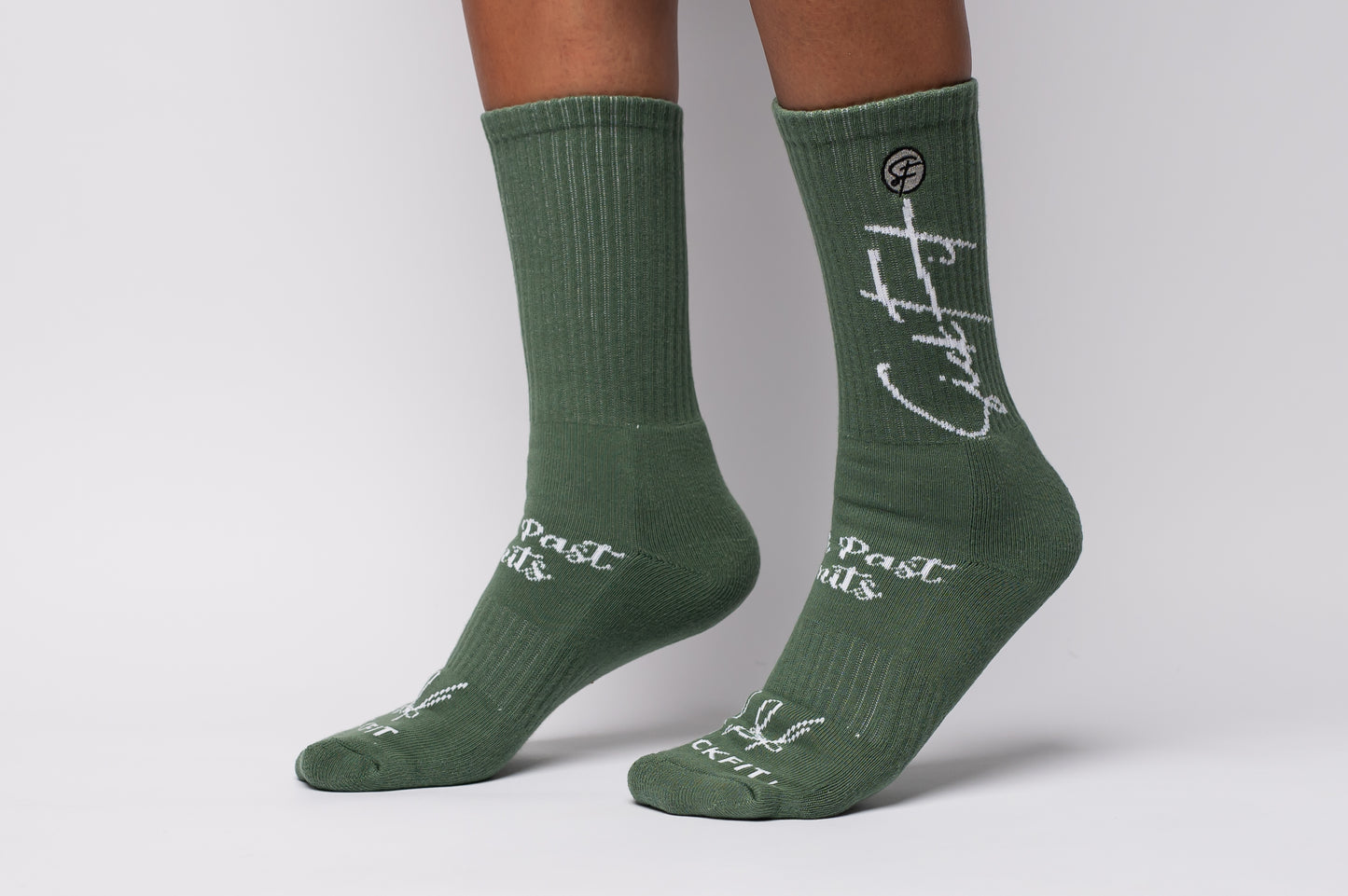 Green socks crew compression with white text on a gray background
