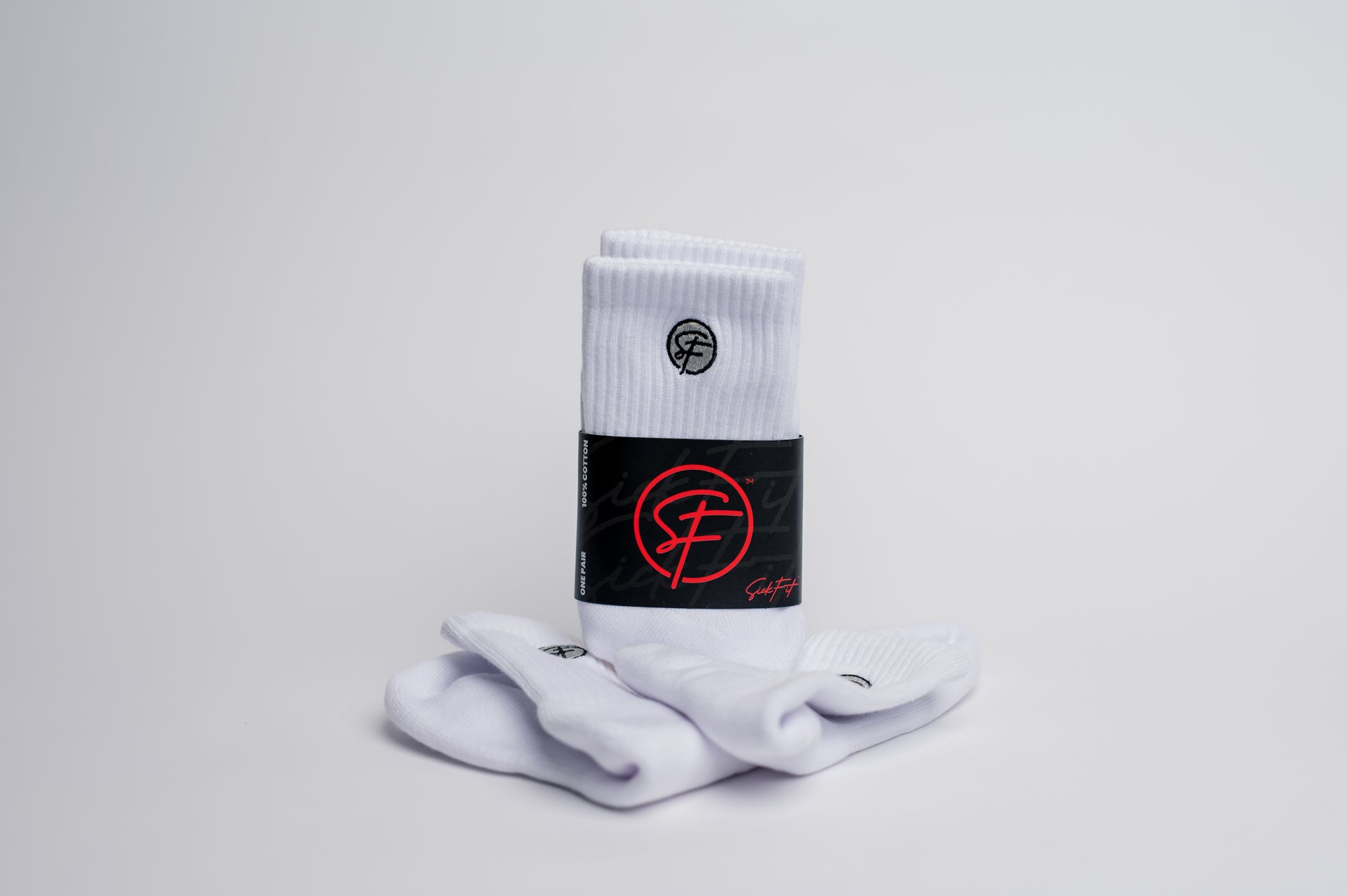 A pair of white quarter socks with a branded logo visible on the ankle area, displayed against a plain background.
