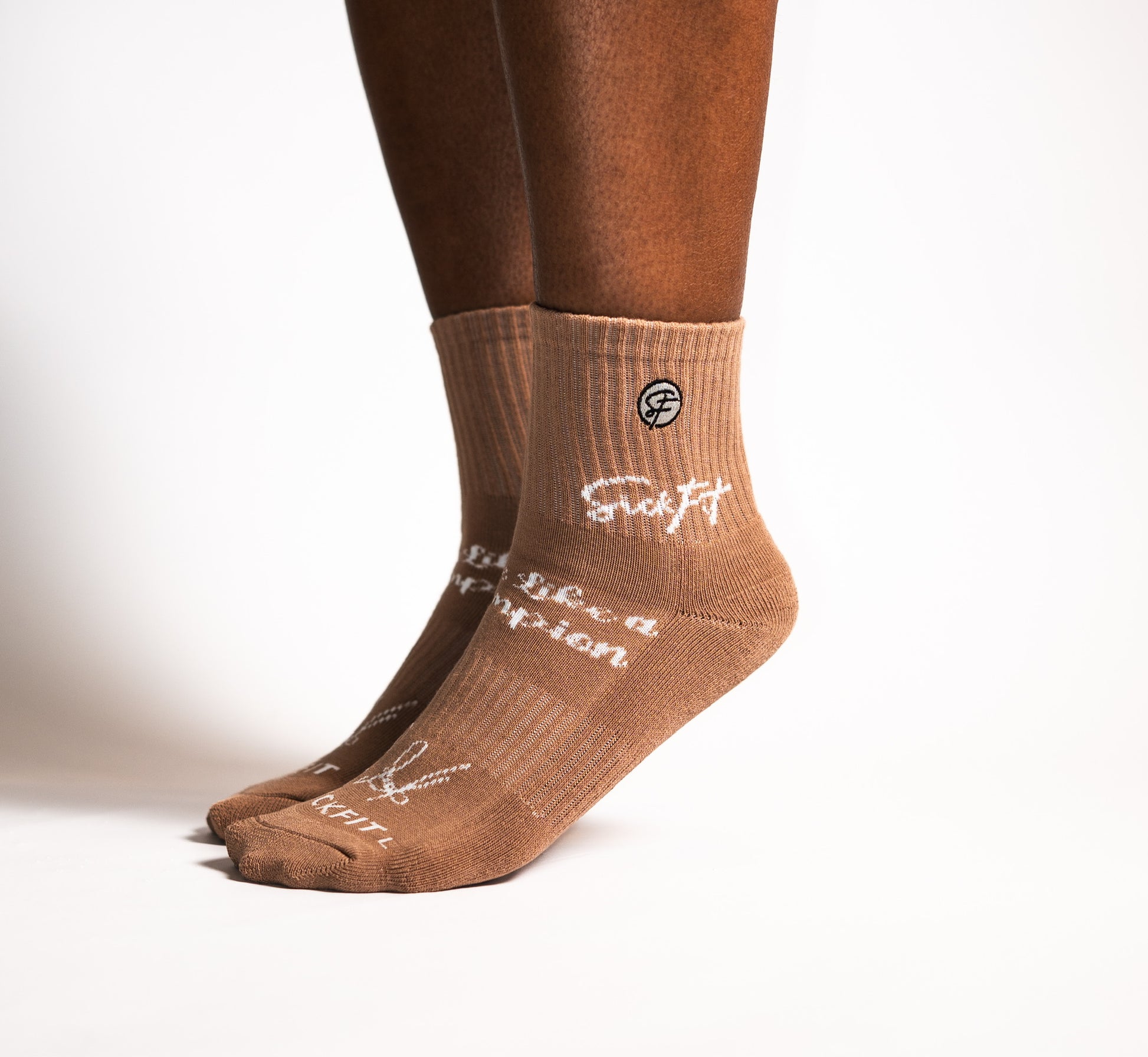 Brown calf socks with white text and logo on a white background