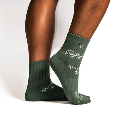 Green calf compression socks with branding on a white background