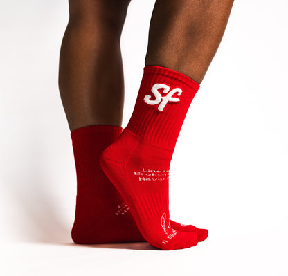 Red socks with white text and Sickfit logo on a white background