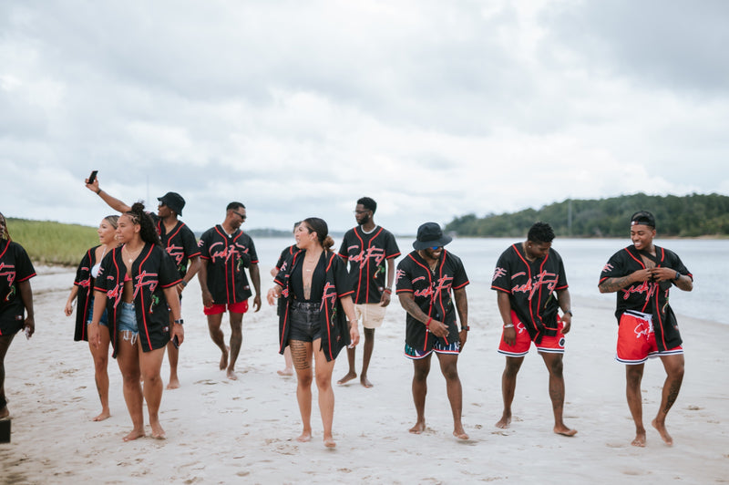 Group of people wearing matching SickFit outfits on a beach