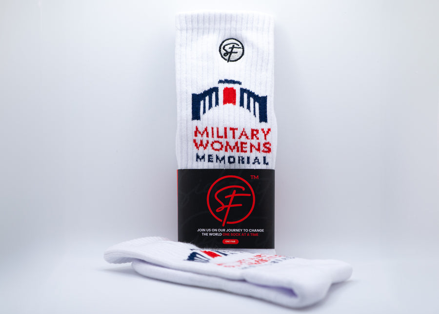 White crew compression socks with a logo and text for "Military Womens Memorial" on a white background