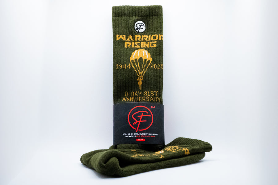 Green crew compression socks with gold text and a black label for Warrior Rising on a white background
