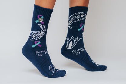 Navy blue crew compression socks with white designs for Bella's Story and text on a plain background