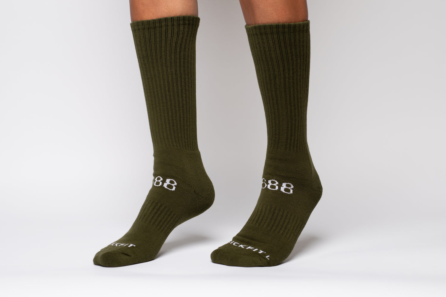 Green crew compression socks with a brand logo on a white background