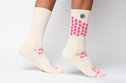White Crew Compression socks with pink ribbons for and text on a white background