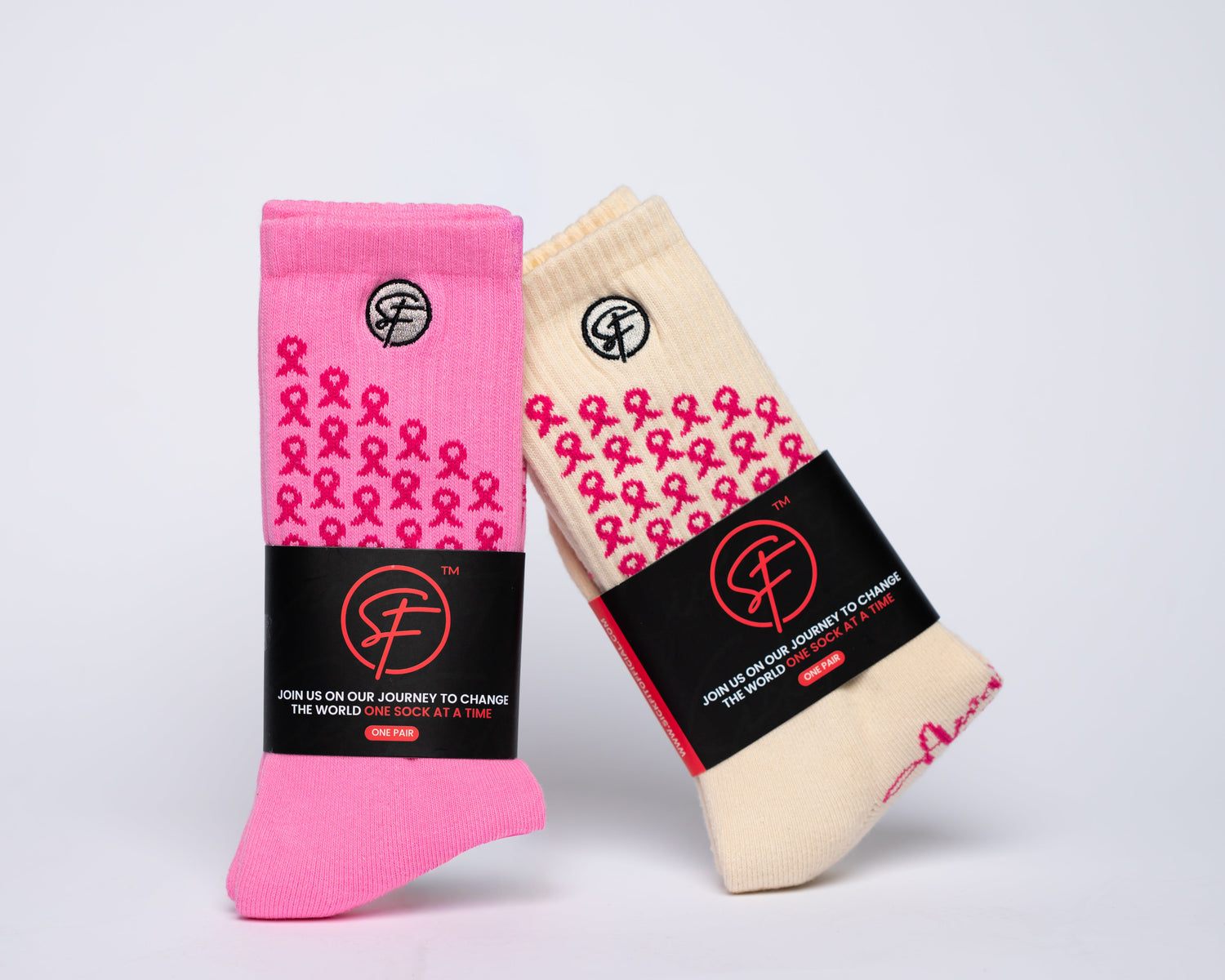 Two pairs of crew compression socks, one pink and one beige, with a common label on a light gray background.