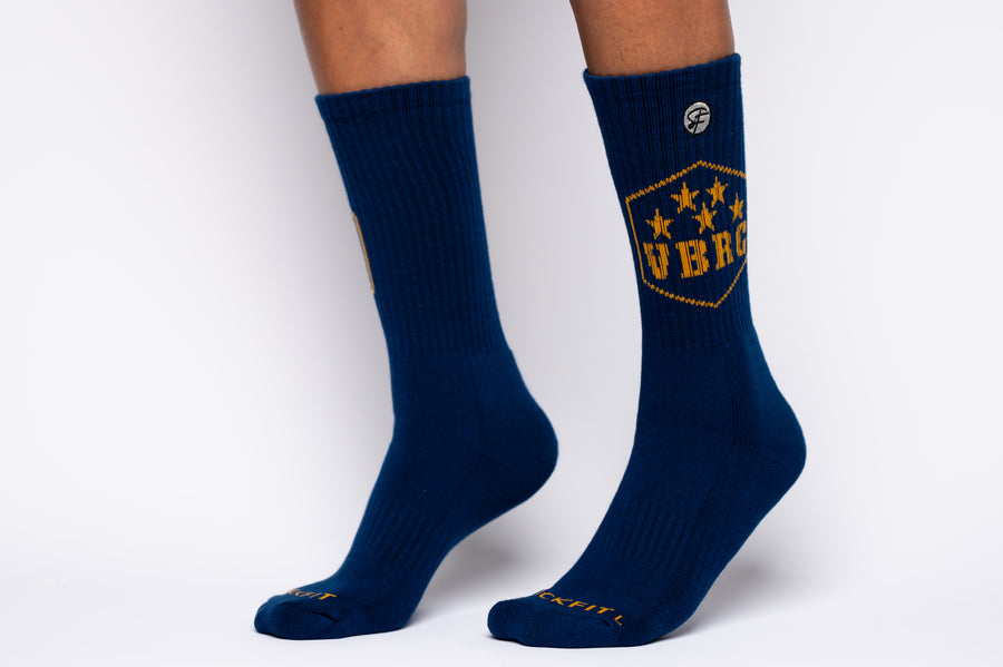 Navy blue crew compression socks with a gold logo on a white background