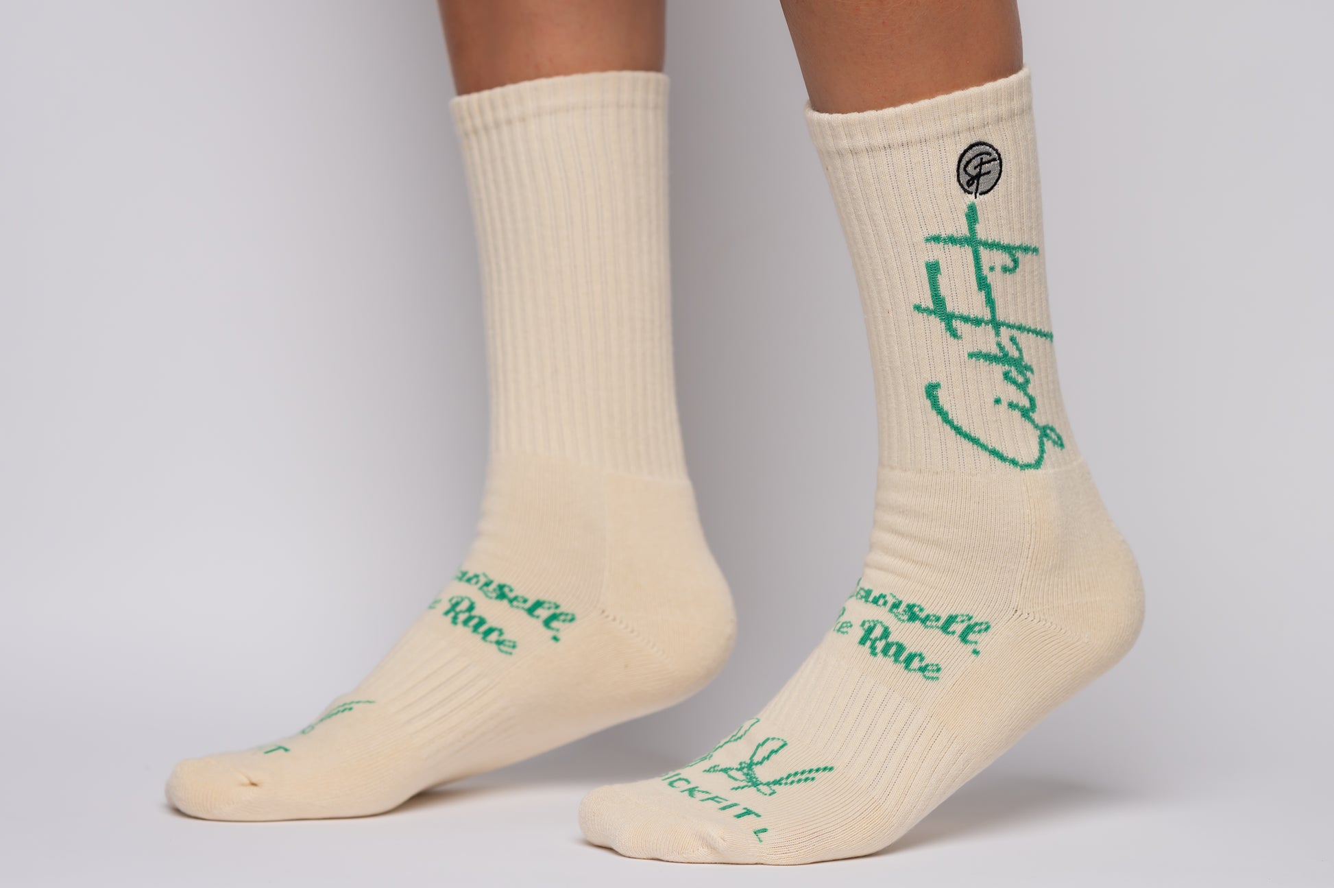 SickFit socks with green text worn by a person on a gray background