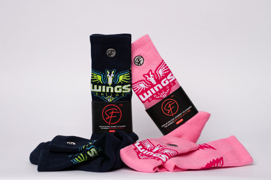 Two pairs of socks, one black and one pink, with visible branding on a light gray background.