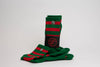 A pair of crew compression holiday socks with bold green and vibrant red stripes, placed on a white surface next to a black SickFit branded bag.