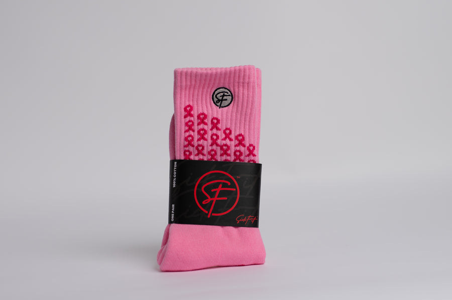 A pair of BCA pink compression socks with black accents and text related to breast cancer awareness.