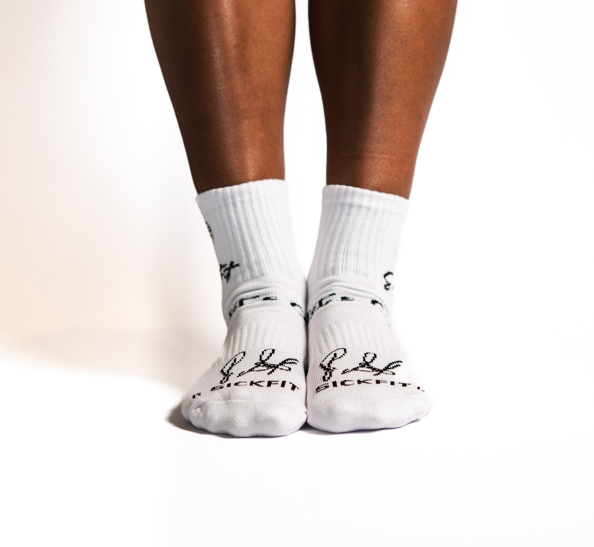 White socks with black designs worn by a person on a white background