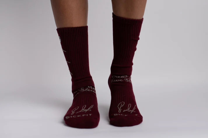 Maroon crew compression socks with brand logo on a plain background