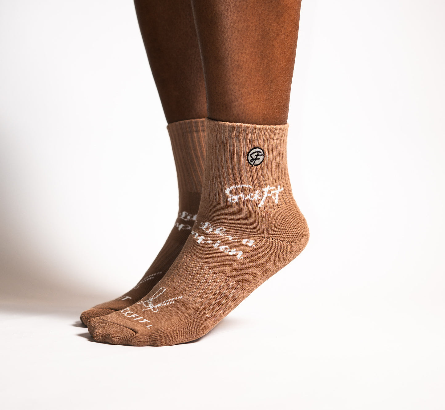 Brown calf socks with white text and logo on a white background